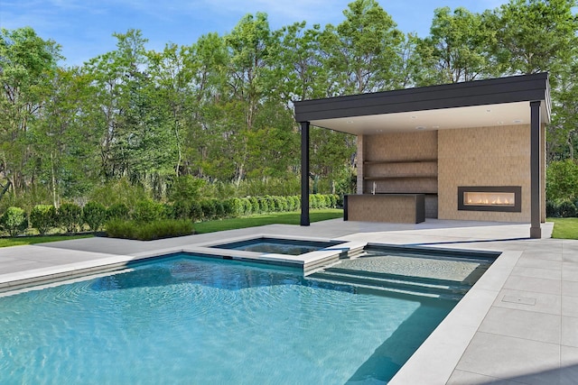 view of swimming pool with an in ground hot tub, a large fireplace, and a patio