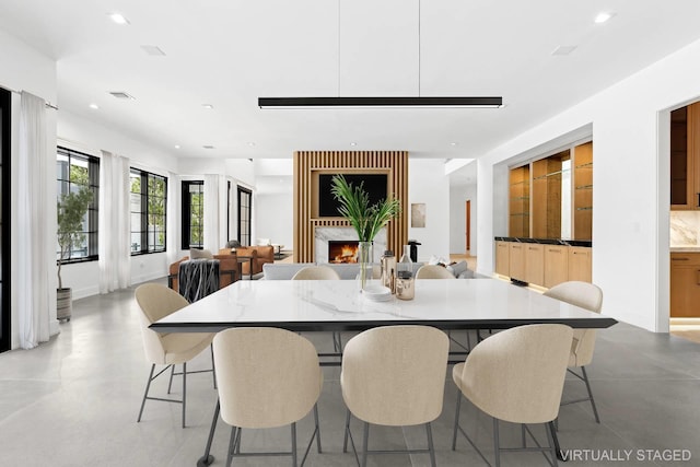 dining room featuring a premium fireplace