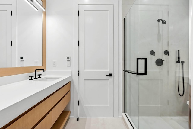 bathroom featuring vanity and an enclosed shower