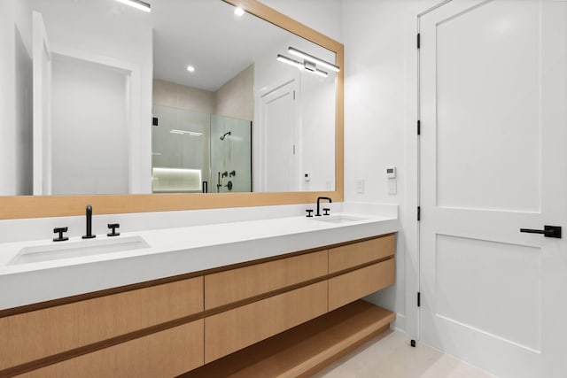 bathroom featuring walk in shower and vanity