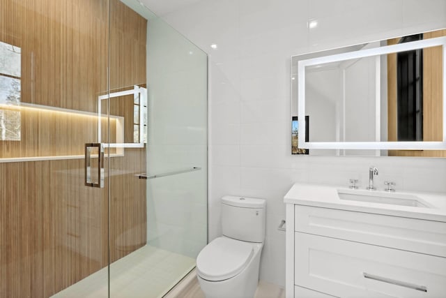 5 Widow Coopers Path, Sag Harbor, NY 11963 - bathroom featuring vanity, toilet, a shower stall, and tile walls