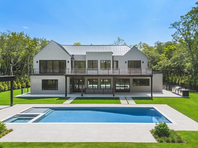5 Widow Coopers Path, Sag Harbor, NY 11963 - rear view of house featuring a balcony, a patio area, brick siding, and a pool with connected hot tub
