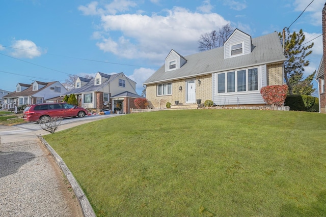 cape cod home featuring a front lawn