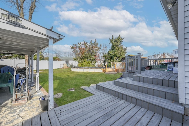 deck featuring a yard and a swimming pool