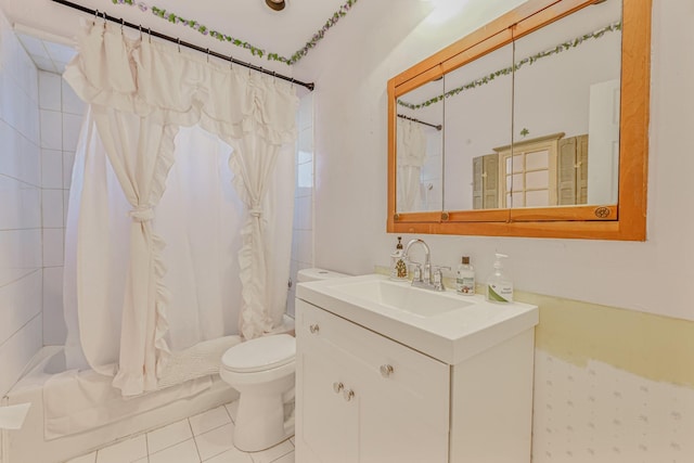 full bathroom featuring tile patterned flooring, vanity, toilet, and shower / bath combo with shower curtain