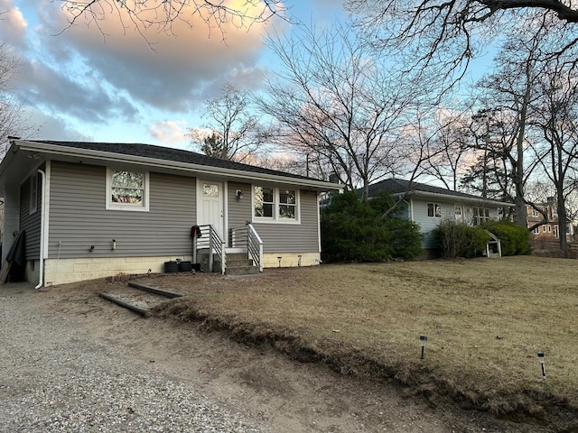 ranch-style home with a yard