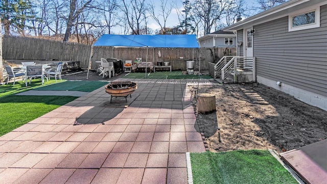 view of patio / terrace featuring an outdoor fire pit