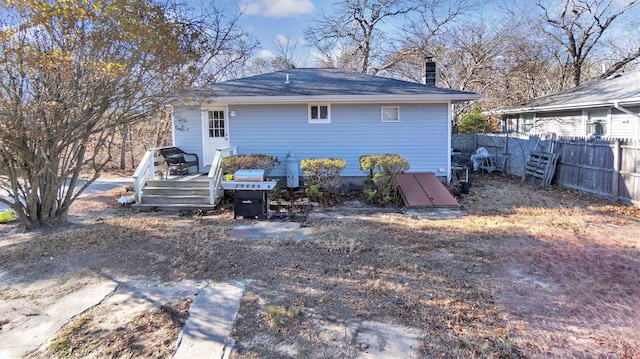 back of house featuring a wooden deck