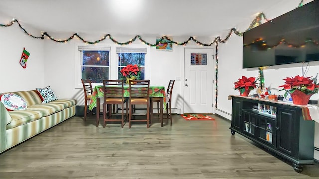 dining room with hardwood / wood-style flooring and a baseboard heating unit