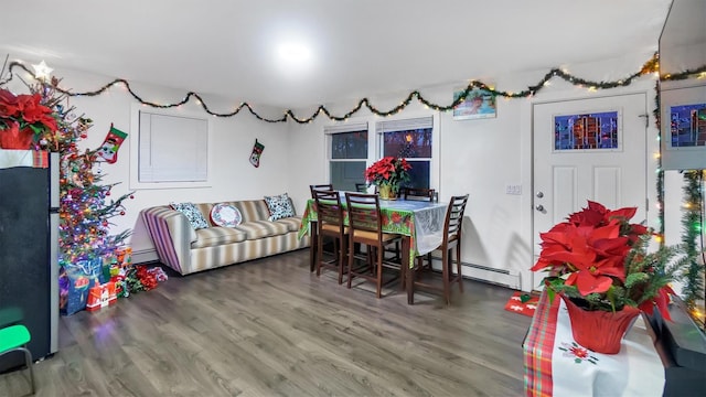 dining room with baseboard heating and hardwood / wood-style flooring