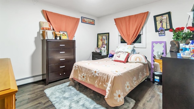 bedroom featuring baseboard heating and dark wood-type flooring