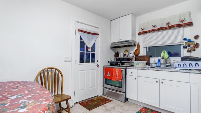 kitchen featuring stainless steel electric stove, white cabinets, and sink