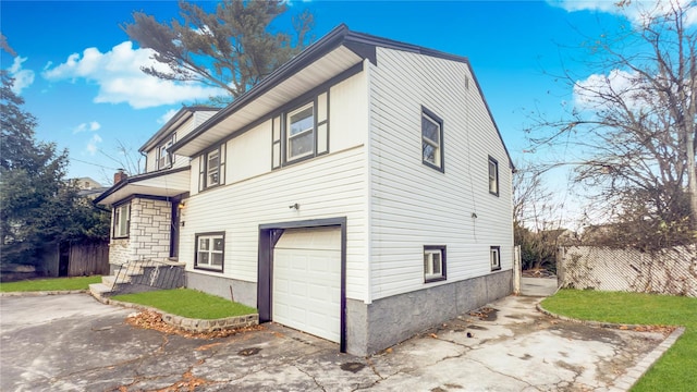 view of side of property with a garage