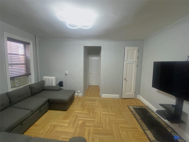 living room featuring cooling unit, radiator, and light parquet floors