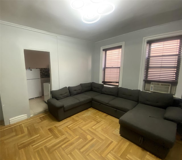 living room featuring light parquet flooring, cooling unit, and crown molding