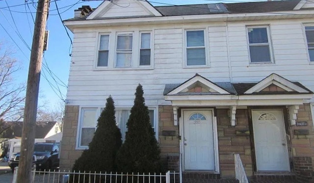 multi unit property featuring a fenced front yard