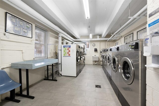 community laundry room featuring washing machine and clothes dryer