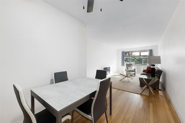 dining area with ceiling fan and light wood-type flooring