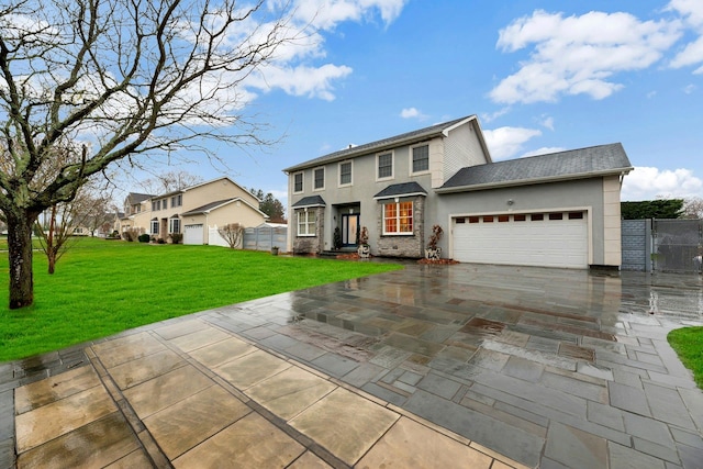 view of front of home with a front yard and a garage