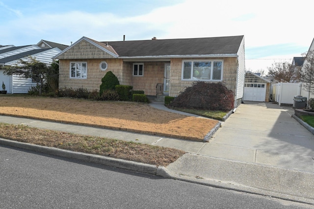 view of front of property featuring central AC unit and a garage