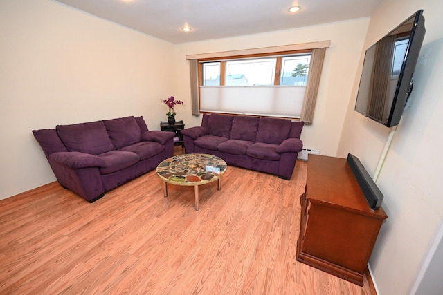 living room featuring light wood-type flooring and baseboard heating