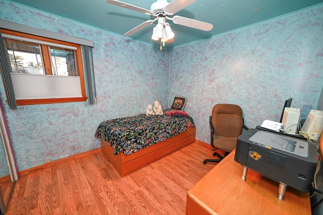 bedroom featuring ceiling fan, ornamental molding, and hardwood / wood-style flooring