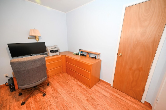 home office with light hardwood / wood-style flooring