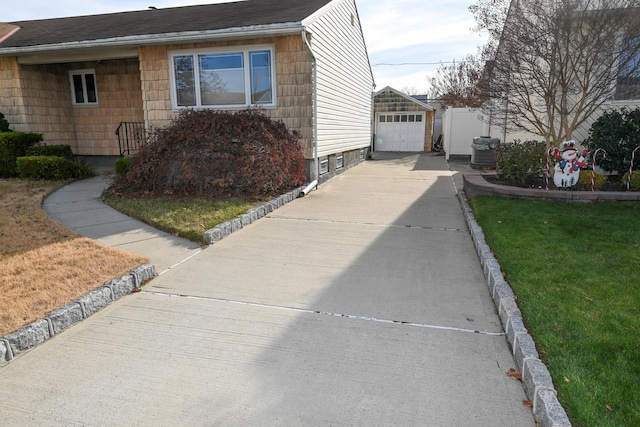 view of side of property with an outbuilding, a yard, and a garage