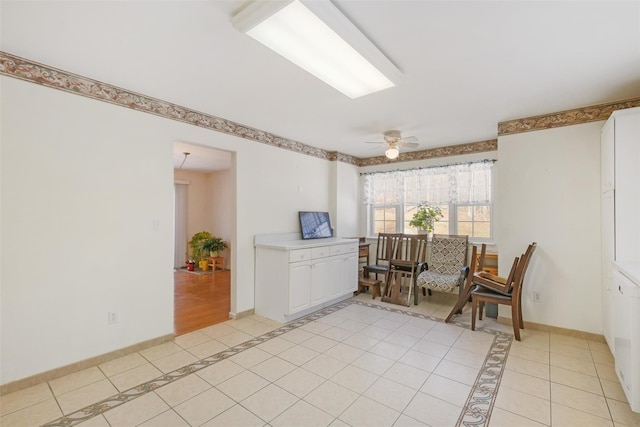 sitting room with ceiling fan and light tile patterned flooring