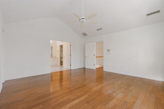 spare room featuring light wood-type flooring, high vaulted ceiling, and ceiling fan