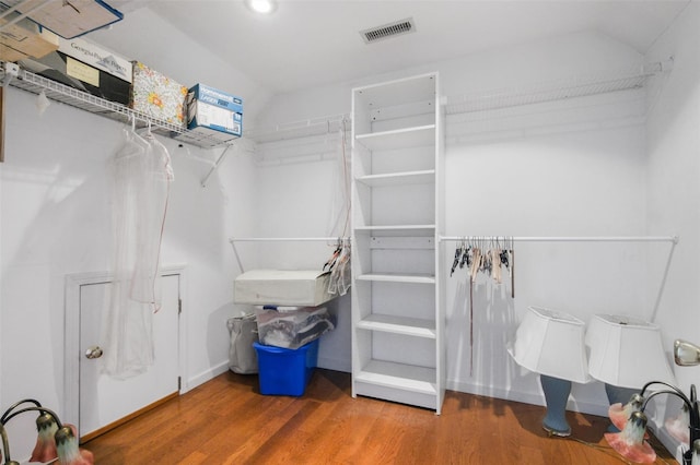 walk in closet with hardwood / wood-style flooring