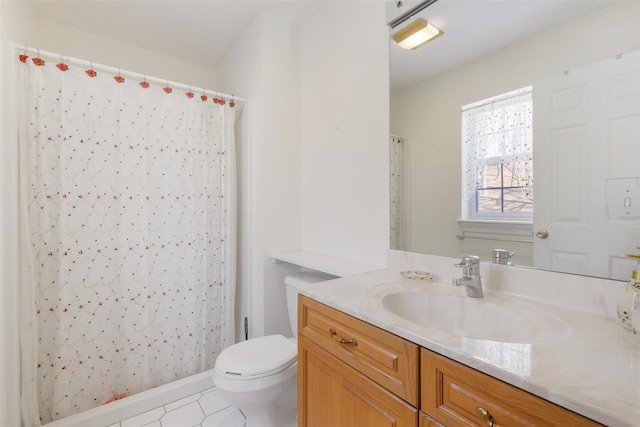 bathroom featuring tile patterned floors, vanity, and toilet