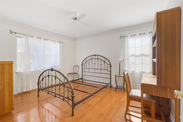 bedroom featuring wood-type flooring and multiple windows