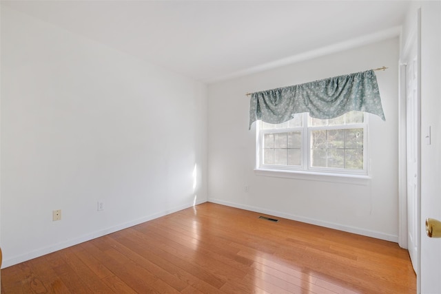 spare room featuring light hardwood / wood-style floors