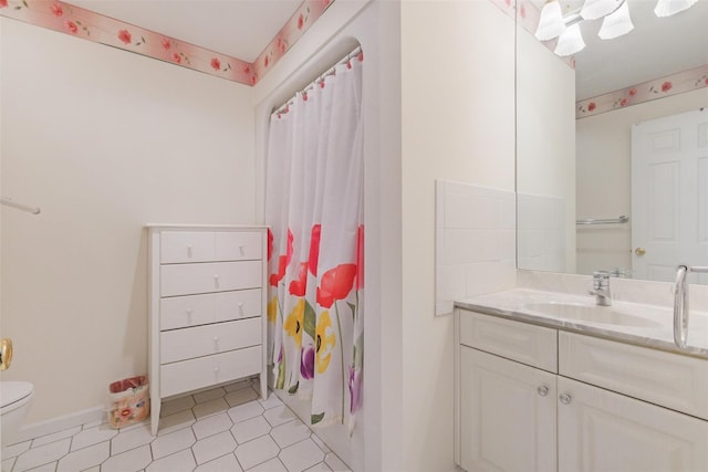 bathroom featuring walk in shower, tile patterned flooring, vanity, and toilet