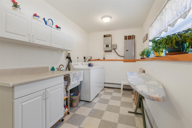 laundry area with sink, cabinets, baseboard heating, electric panel, and washer and clothes dryer