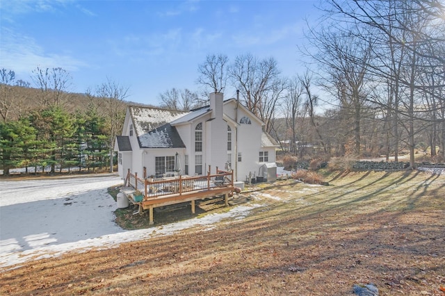 back of property with a wooden deck