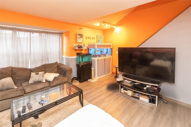 living room with track lighting and light hardwood / wood-style flooring