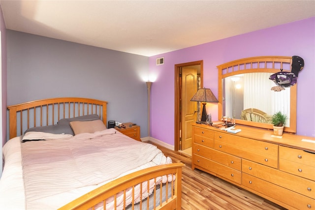 bedroom with light hardwood / wood-style flooring