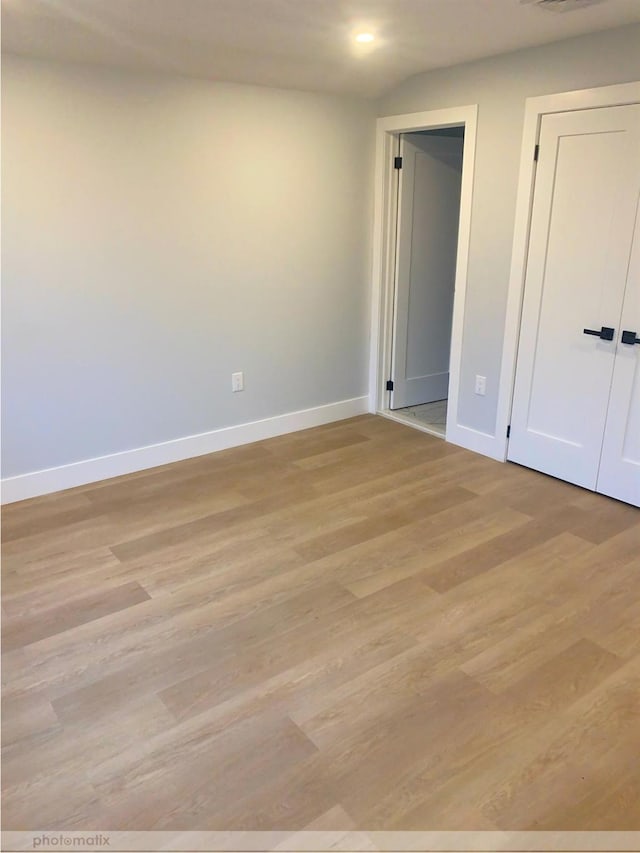 empty room with light hardwood / wood-style floors