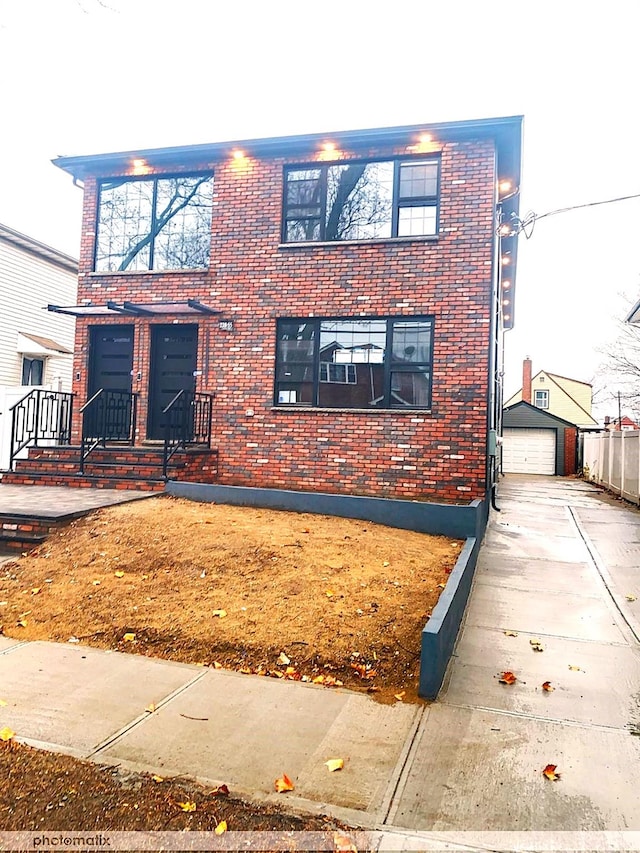 view of front of house with a garage and an outdoor structure