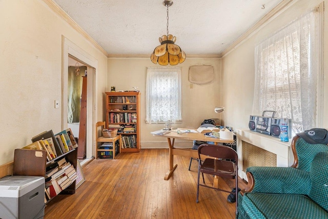 home office featuring hardwood / wood-style floors and crown molding