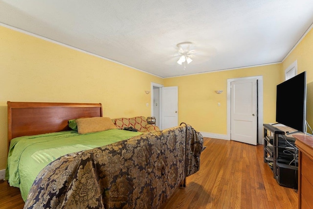 bedroom with wood-type flooring and ceiling fan