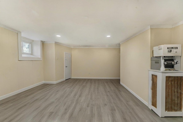 basement with ornamental molding and light wood-type flooring