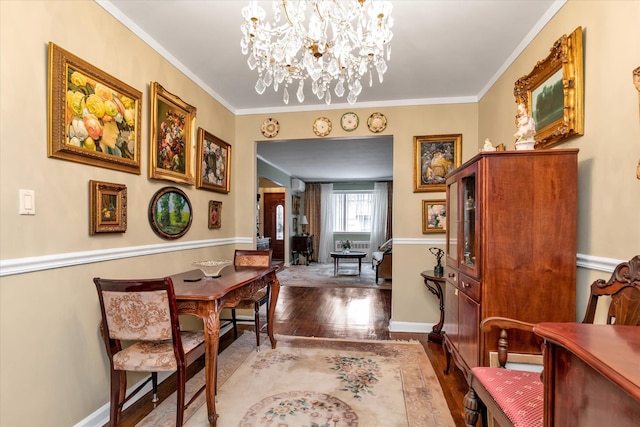 dining room featuring hardwood / wood-style floors, ornamental molding, and a notable chandelier