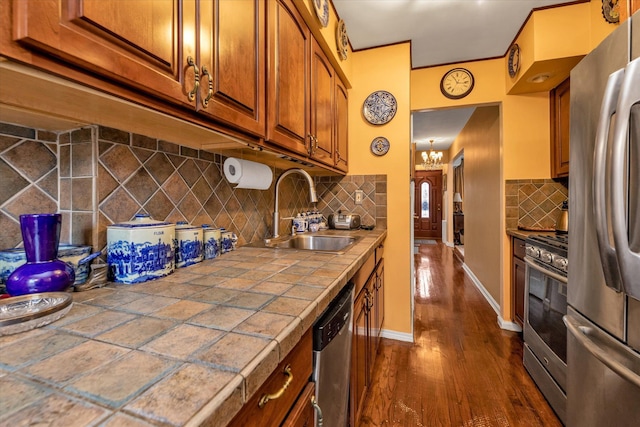 kitchen featuring backsplash, appliances with stainless steel finishes, sink, and tile countertops