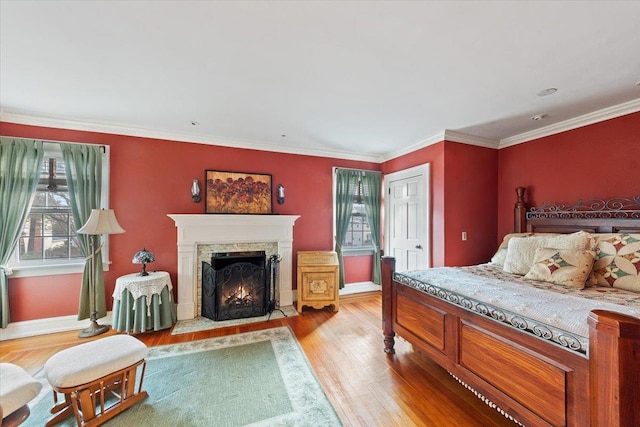 bedroom with light hardwood / wood-style floors and crown molding