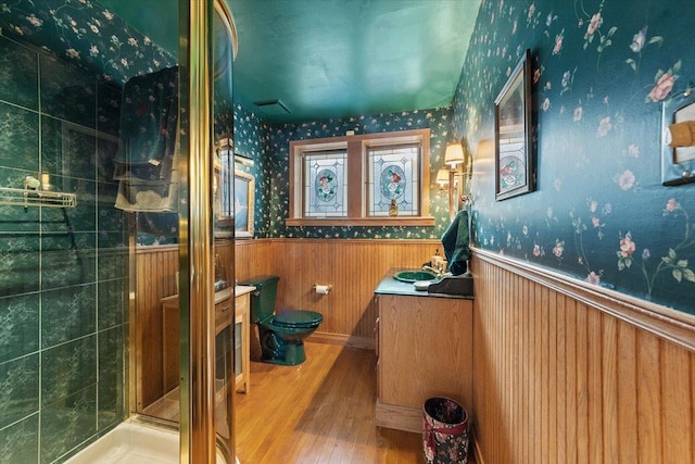 bathroom featuring an enclosed shower, vanity, toilet, and hardwood / wood-style floors