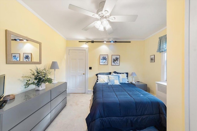 bedroom featuring ceiling fan, ornamental molding, and light carpet