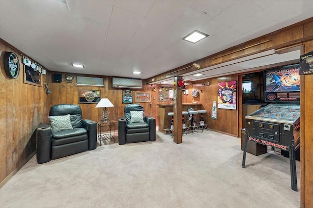 game room with carpet floors and wood walls